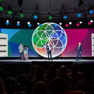 Event-Photography Speakers discussing business strategy on stage at a conference in Sacramento Convention Center, documented by Coldea Productions' event photography