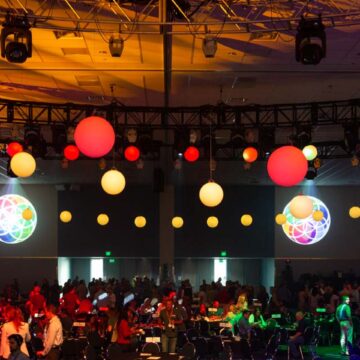 Event-Photography DJ performing at an event with vibrant lights and hanging decorations at Santa Clara Convention Center, captured by Coldea Productions.