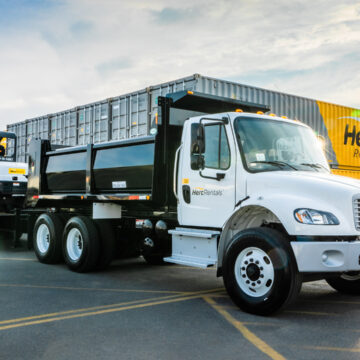 Herc Rentals truck with equipment trailer carrying construction machinery, photographed by Coldea Productions Product-Photography