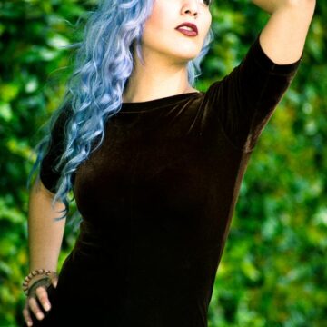 Portrait of model Kimiya Khosrovani with lavender hair posing in a natural outdoor setting in Tustin, CA, captured by Coldea Productions.