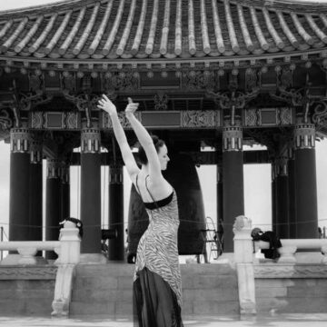 Fashion and dance portrait of a woman posing gracefully in front of the Korean Friendship Bell in San Pedro, Los Angeles, captured by Coldea Productions.
