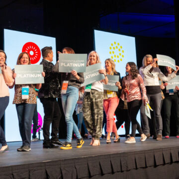 Convention-Photography This image captures a lively celebration on stage at the Pasadena Convention Center, with Coldea Productions showcasing their expertise in event photography by capturing engaging moments of participants enjoying the event.