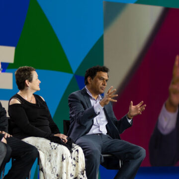 Event-Photography Panel of speakers discussing on stage at the San Diego Convention Center during a convention, with event photography by Coldea Productions.