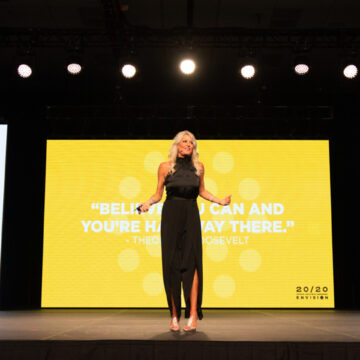 Convention-Photography Speaker on stage delivering an inspirational message at the Los Angeles Convention Center, with vibrant visuals captured by Coldea Productions