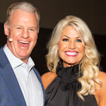 Conference speakers on stage with videographer filming at Los Angeles Convention Center, captured by Coldea Productions