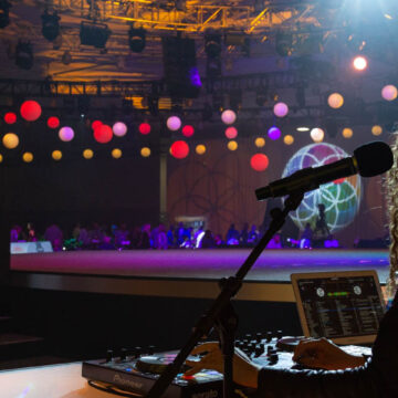 Event-Photography DJ performing at an event with vibrant lights and hanging decorations at Santa Clara Convention Center, captured by Coldea Productions.