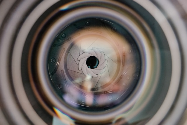 Close-up of a professional camera lens aperture symbolizing the speed and precision of human visual perception, captured by Coldea Productions.