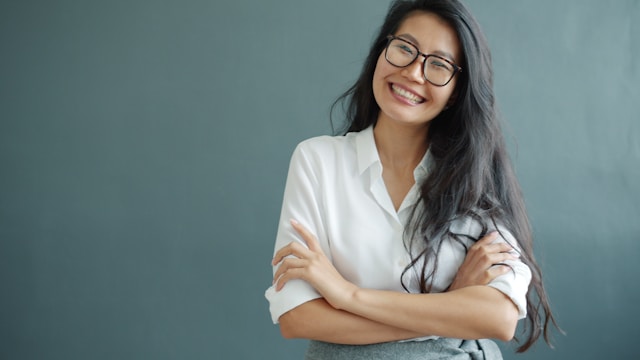 Professional woman smiling confidently during a corporate headshot session.