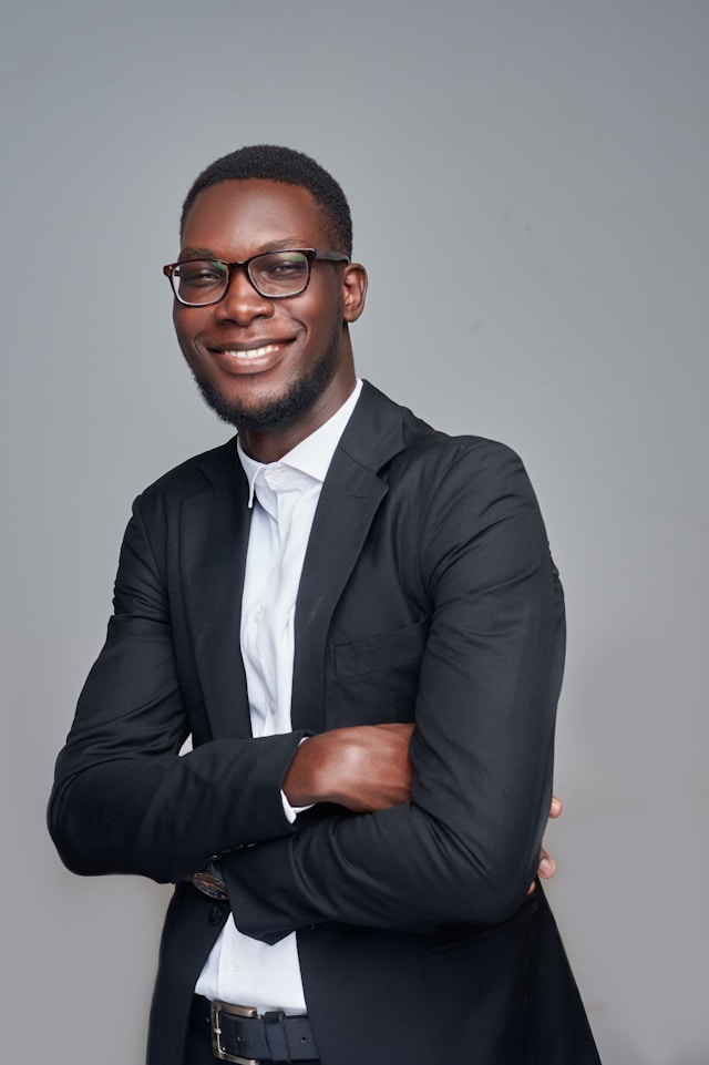 Professional man in suit smiling during corporate headshot session.