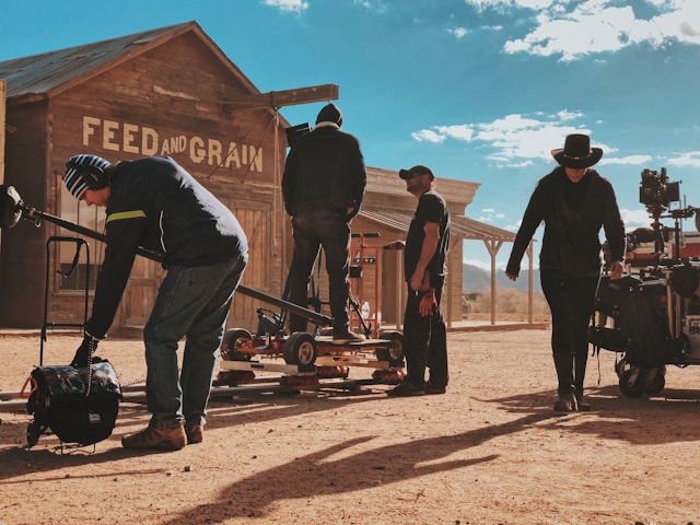 Film crew working on a video production set in a western-themed location, symbolizing the essential equipment and teamwork needed for high-quality production.