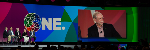Panel discussion on a vibrant stage with a keynote speaker displayed on a large screen, captured by Coldea Productions event photography in Long Beach near Los Angeles