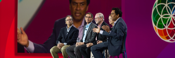 Panel discussion at a corporate event with speakers on stage, photographed by Coldea Productions, emphasizing their event photography capabilities.