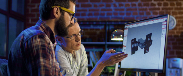 Two professionals collaborating on a design project using 3D modeling software, representing Coldea Productions' expertise in creating educational and explainer videos.