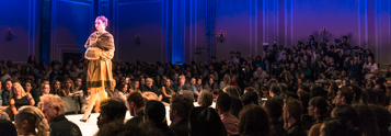 Model walking down the runway at a packed fashion event, showcasing Coldea Productions' nationwide fashion photography services.