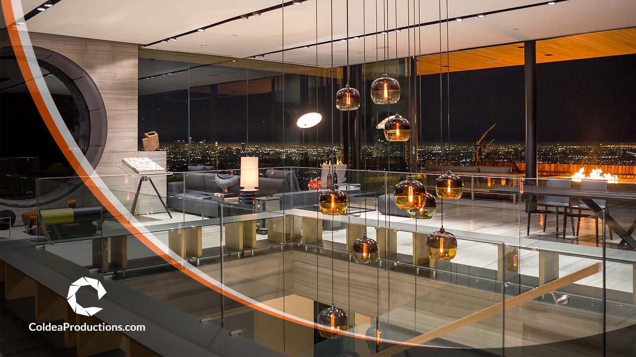 A luxurious modern home with elegant lighting and a breathtaking city view at night, featured in a real estate video produced by Coldea Productions.