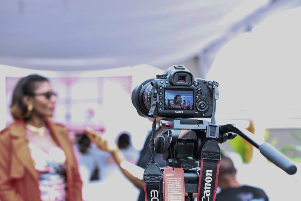 A person giving an interview in front of a camera, a form of personalized video marketing.