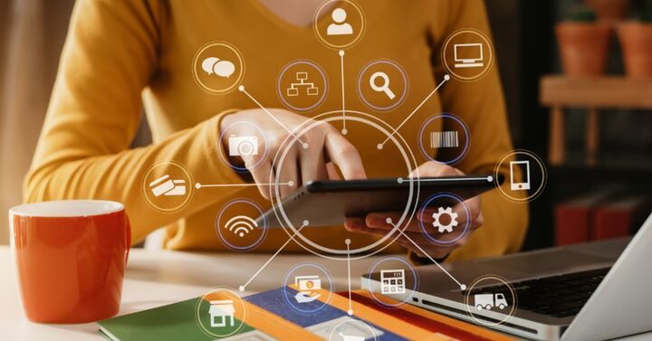 Person using a tablet surrounded by icons representing social media marketing tools and strategies for business growth.