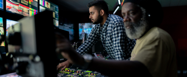 Technicians operating video production equipment in a live-streaming control room at Coldea Productions.