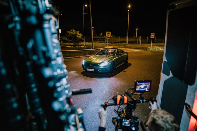 Behind-the-scenes video production of a luxury car commercial showing a sports coupe filmed at night by Coldea Productions in Anaheim, California.