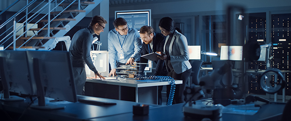 A team of engineers collaborating in a high-tech manufacturing lab, showcasing Coldea Productions' expertise in creating manufacturing and safety videos in the USA.