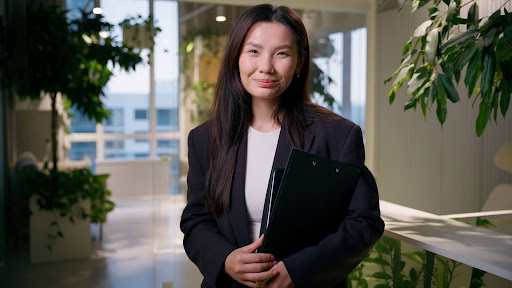 Corporate lawyer in modern office holding documents, representing law firm marketing and professional authority.
