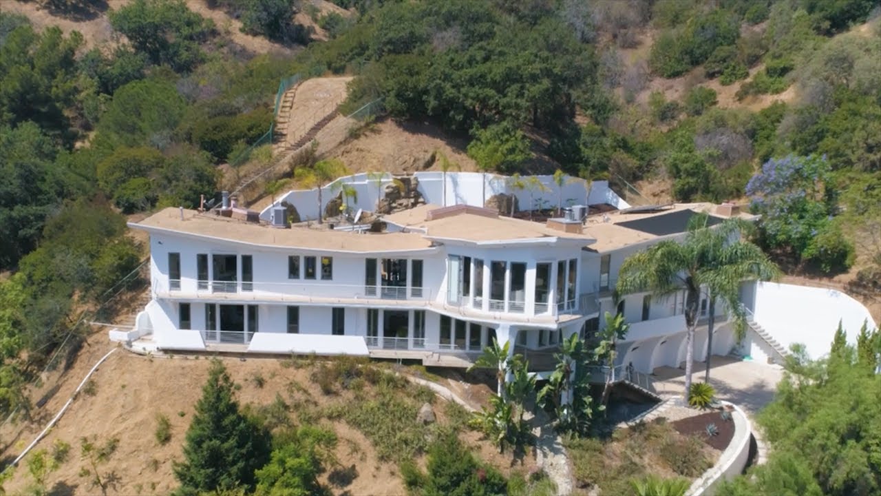 Aerial view of a luxury property in the Hollywood Hills, showcasing modern architecture and hillside landscaping for a real estate video.