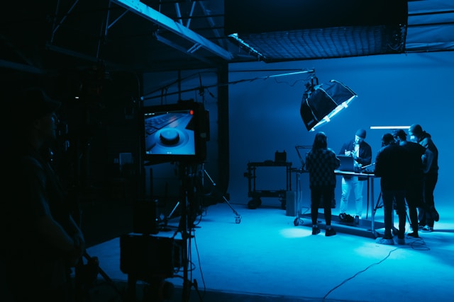 Creative photography team working under studio lights during a shoot.