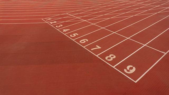 Running track with numbered lanes symbolizing how consistency can be measured and tracked over time.