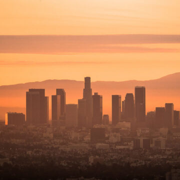 A sunset view of the Los Angeles skyline, showcasing the city's iconic buildings, captured as part of Coldea Productions' real estate photography services.