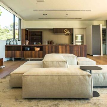 Modern, open-plan living area with designer furniture and stylish kitchen, photographed by Coldea Productions as part of their real estate photography services