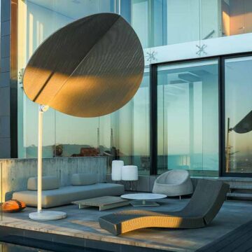 Modern outdoor patio area with stylish furniture and large sunshade, captured by Coldea Productions for real estate photography