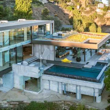 Aerial view of a modern luxury home with an expansive rooftop terrace and pool, showcasing Coldea Productions' expertise in real estate photography