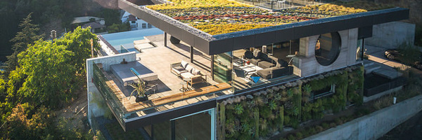 An aerial view of a luxurious modern home with a green rooftop in Manhattan Beach, CA, showcasing Coldea Productions' real estate video and photography services.