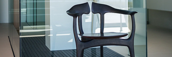 Sleek black modern chair with unique design in a minimalist interior, captured for real estate promotion by Coldea Productions.