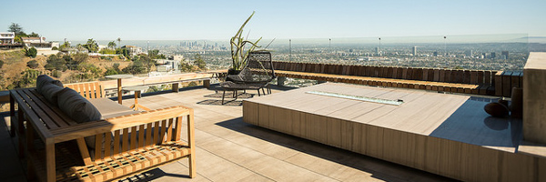 Luxury outdoor patio with modern furniture and a stunning panoramic view of Los Angeles, captured for real estate marketing by Coldea Productions.