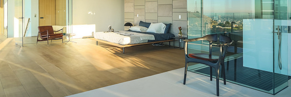 Modern luxury bedroom with glass walls and scenic views, ideal for real estate video and photography by Coldea Productions.