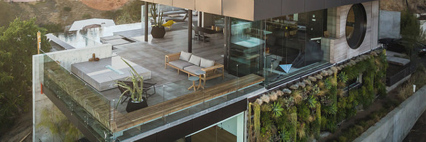 Modern luxury home with glass walls and spacious terrace, ideal for real estate video and photography by Coldea Productions.