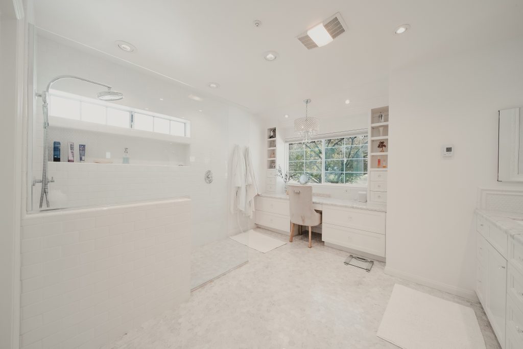 Bright and spacious luxury bathroom with large walk-in shower and vanity area.
