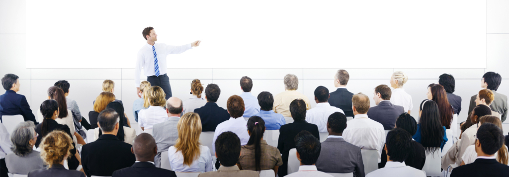 Professional trainer presenting to a diverse audience, ideal for nationwide training videography services by Coldea Productions.