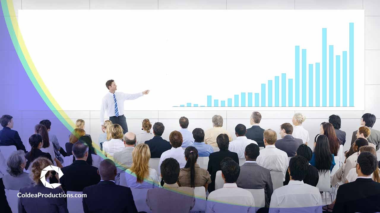 Business professional presenting a bar graph to a large audience, representing Coldea Productions' presentation video production services.