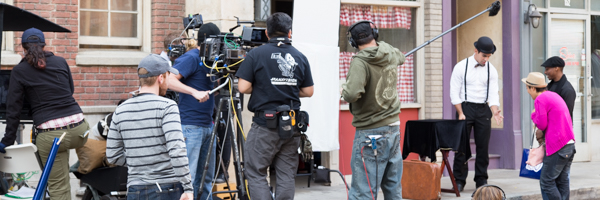 Film crew capturing a commercial scene on an urban set, showcasing Coldea Productions' video commercial services in Long Beach, California