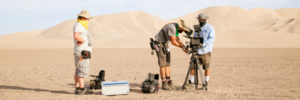 Coldea Productions crew setting up camera equipment in the desert for a video shoot, showcasing video production services in Glendale, Arizona.