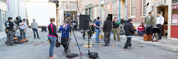 Film crew setting up for a video commercial shoot on a city street set, part of Coldea Productions' services in Loma Linda, California