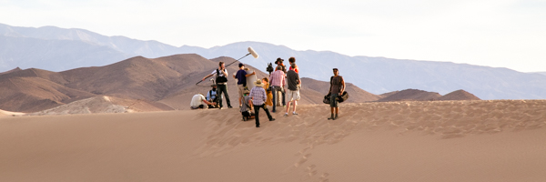 A film crew working on a video commercial in a scenic desert setting, highlighting Coldea Productions' expertise in outdoor video production.