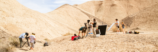 Professional video production team filming in Tucson's desert terrain, demonstrating Coldea Productions' capability for on-location video services.