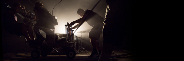 Coldea Productions crew filming a dramatic drum scene for a commercial video in Culver City, California, using a professional camera dolly setup.