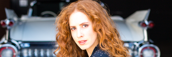 Close-up of a model posing in front of a classic car during a Coldea Productions commercial shoot in Anaheim, California.