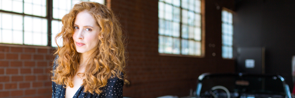 Portrait of an actress with curly red hair on set at a video production shoot in Santa Monica, California.