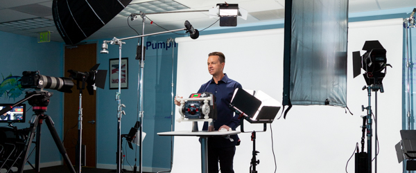 Alexis Mendez filming Rob Gledhill explaining the Blue-White Chemical Metering Pump.