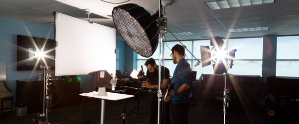 Alexis Mendez and Alex Stoica from Coldea Productions filming a Blue-White Peristaltic Metering Pump with professional video equipment.